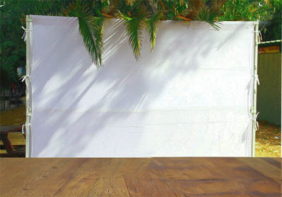 Jewish festival of Sukkot. Traditional succah (hut). Empty wooden old table for product display and presentation